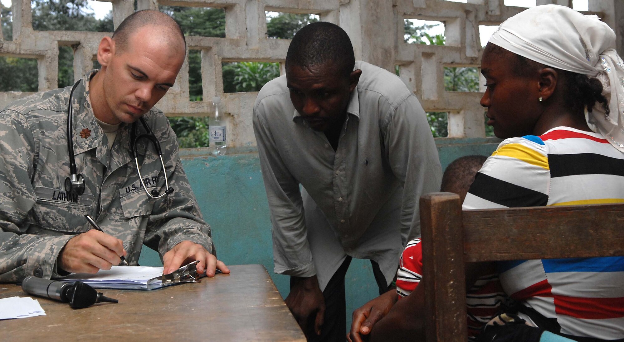 Maj. (Dr.) Joshua Latham prescribes medication to a patient during a medical outreach visit July 2, 2013, in Gondor Town, Liberia. Operation Onward Liberty advisers have been mentoring the Armed Forces of Liberia since 2010. OOL provides mentorship to the AFL to produce a capable, respected force able to protect Liberian interests in the West African region. . Latham is an AFL medical mentor deployed with Operation Onward Liberty. (U.S. Air Force photo/Master Sgt. Brian Bahret)