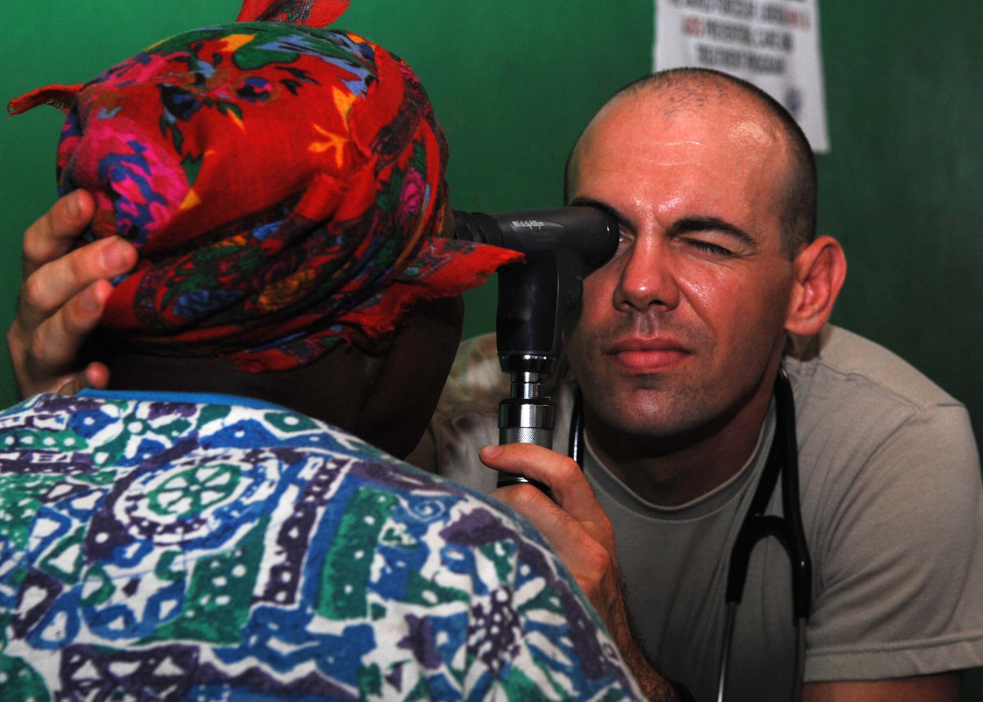 Maj. (Dr.) Joshua Latham gives a patient a medical evaluation during a medical outreach visit July 2, 2013, in Gondor Town, Liberia. The Armed Forces of Liberia led a 14-person medical outreach team including doctors, nurses and a support staff to three villages deep in the jungles of Grand Cape Mount County from July 1 - 4. The medical outreach mission was a first for the AFL which was restructured in 2005 following 15 years of civil war. Latham is an AFL medical mentor deployed with Operation Onward Liberty. (U.S. Air Force photo/Master Sgt. Brian Bahret)