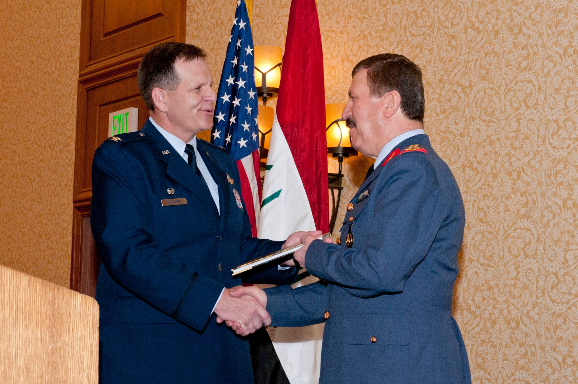 Col. Mick McGuire (left), presents a gift to Staff Lt. Gen. Hamad Ameen Ahmed Mam Seeny Anwer during the inaugural graduation ceremony of two Iraqi F-16 pilots.  (U.S. Air National Guard photo by Tech Sgt. Hollie Hansen/Released)