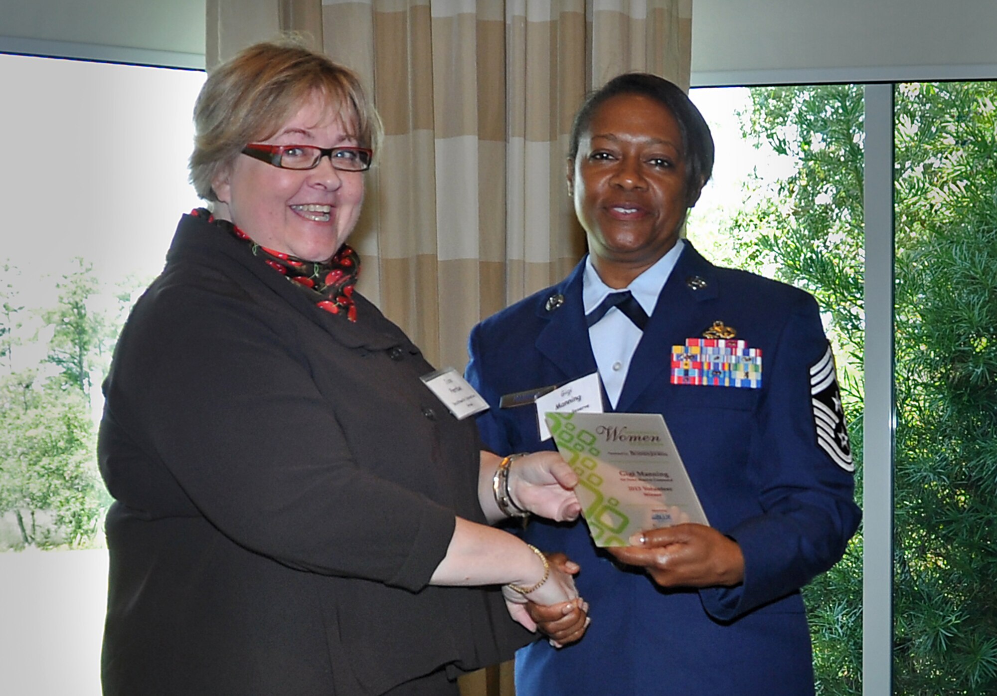 Chief Master Sgt. Gigi Manning is congratulated by Jane Perdue after being named one of Charleston’s Influential Women in Business at an awards luncheon July 11 on Daniel Island. The Charleston Regional Business Journal selected Manning as a winner in the Volunteer category due to her extensive involvement with local non-profit and charity organizations. Manning is the 315 AW command chief master sergeant, and Perdue is the Center for Women board of directors president. (U.S. Air Force Photo/Capt. Kimberly Champagne)
