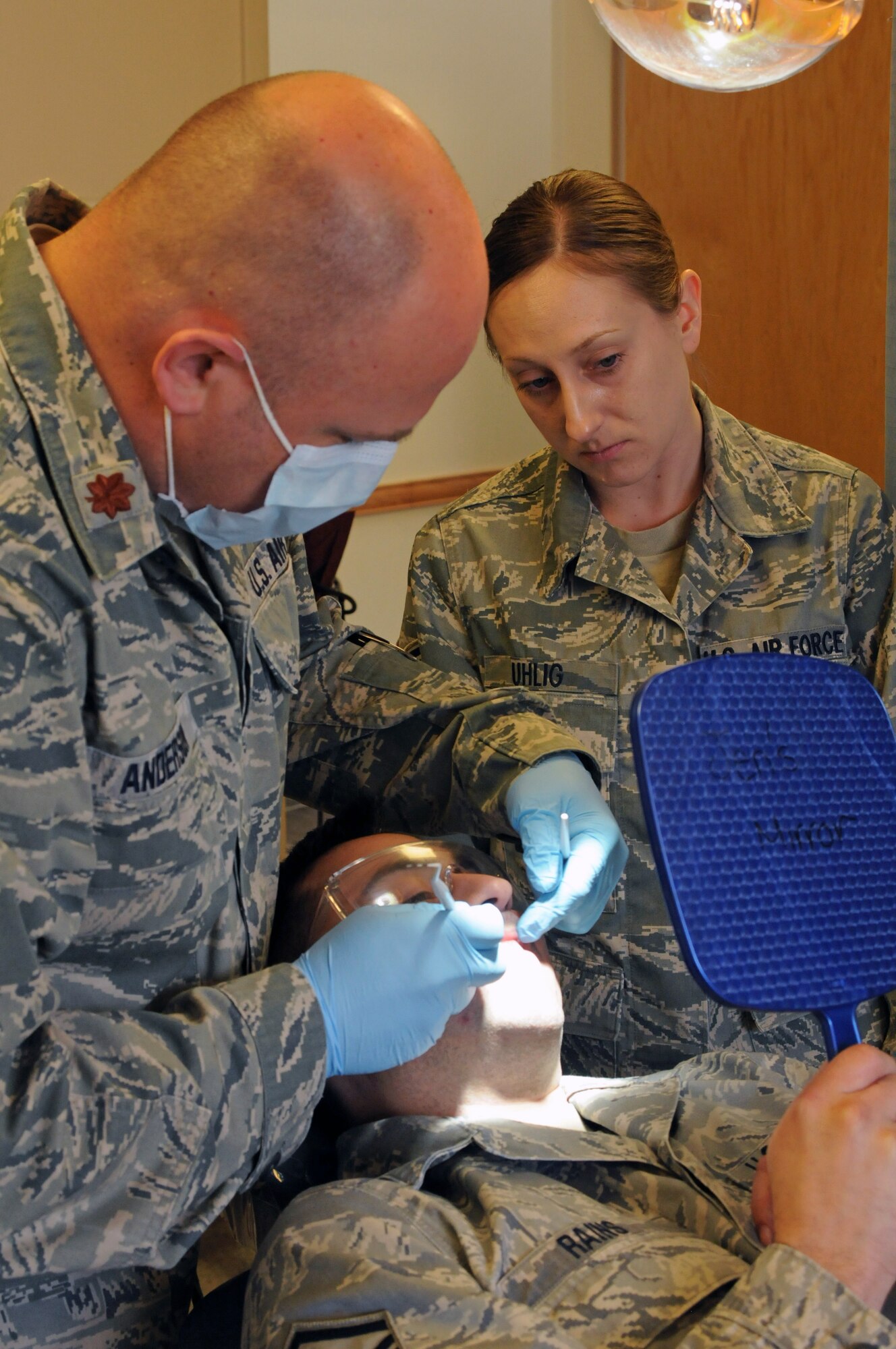 Major Paul Anderson, 173rd Medical Group, performs a routine dental exam on Master Sgt. Vaughn Rains, 173rd Security Forces Squadron, with assistance from Tech. Sgt. Barbara Uhlig, at Kingsley Field, Klamath Falls, Ore., April 6, 2013. (U.S. Air National Guard photo by Airman 1st Class Penny Hamilton)