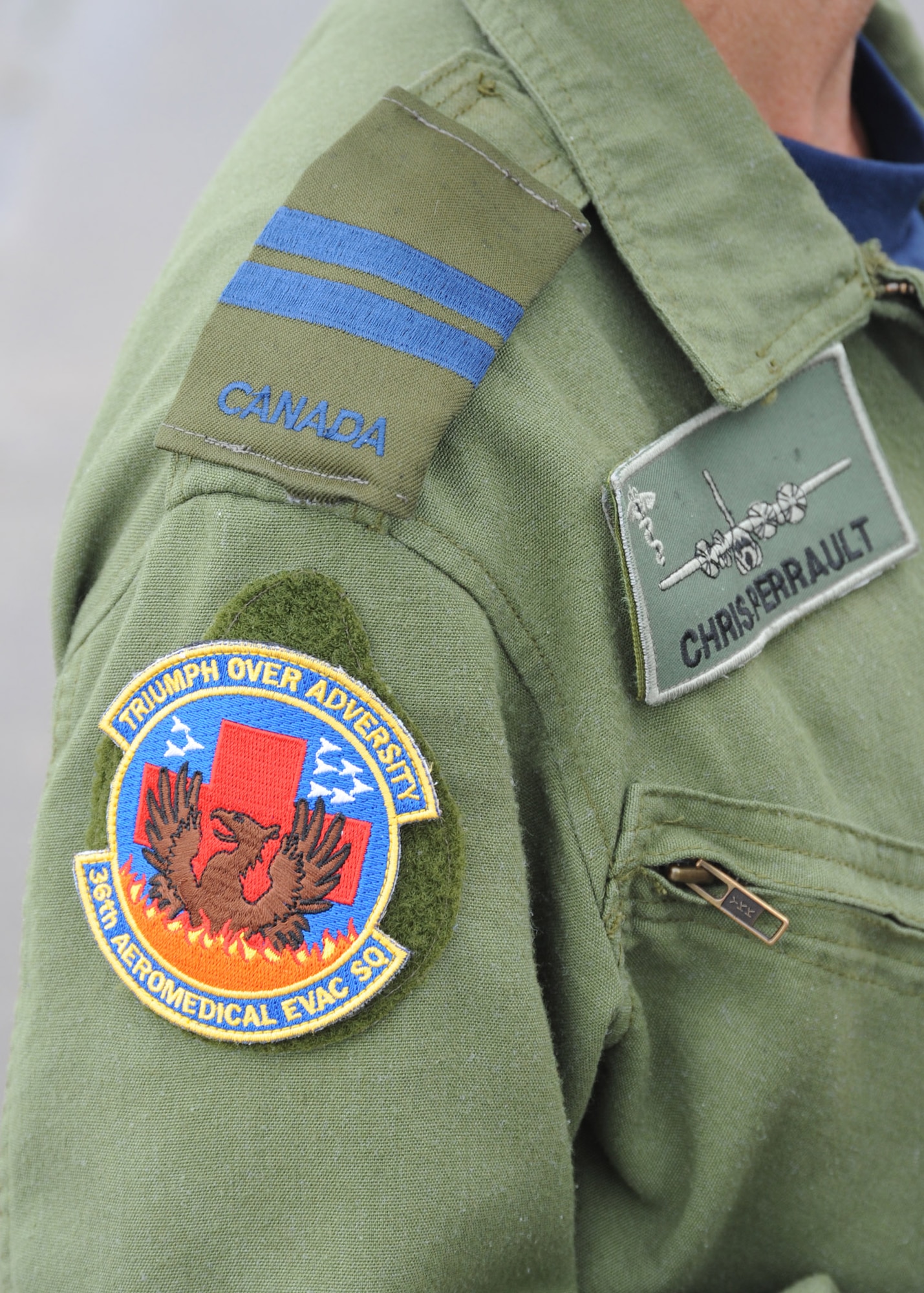 A member of the Royal Canadian Air Force wears a 36th Aeromedical Evacuation Squadron unit patch during a training mission at Pope Field, N.C., on July 12, 2013.  Military members commonly trade memorabilia including unit patches, challenge coins and flags during joint-force missions.  (U.S. Air Force photo by Tech. Sgt. Peter R. Miller)