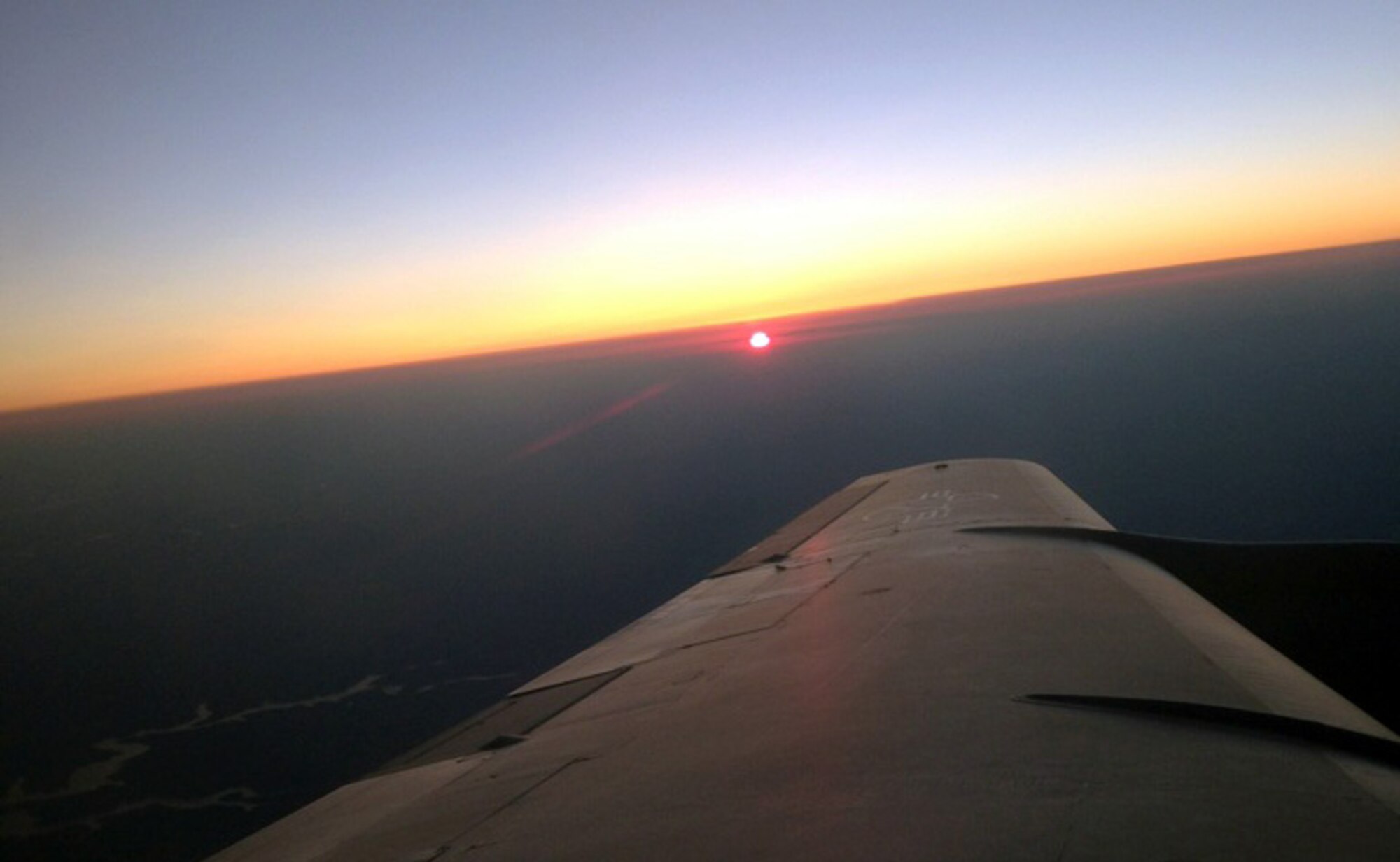 The Kansas sun sinks below the horizon off the wing of a KC-135 Stratotanker assigned to McConnell Air Force Base, Kan., July 11, 2013. The KC-135 was being operated by an aircrew made up of Reservists from the Air Force Reserve 931st Air Refueling Group, who were conducting an air refueling training mission. (U.S. Air Force photo by Senior Master Sgt. Ray Lewis)
