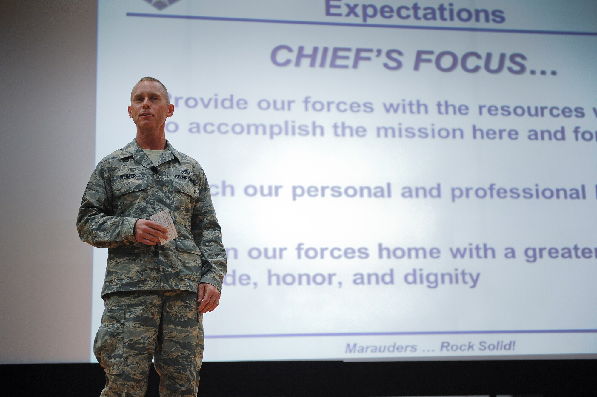 “I’ve seen a very impressive team atmosphere here,” said Weimer.  “I love it.”
Chief Master Sgt. John Weimer, the 386th Air Expeditionary Wing’s Command Chief, speaks to a large group of deployed Airmen during a commander’s call Friday, July 5, 2013.  (U.S. Air Force Photo by 1st Lt. Nathan Wallin)
