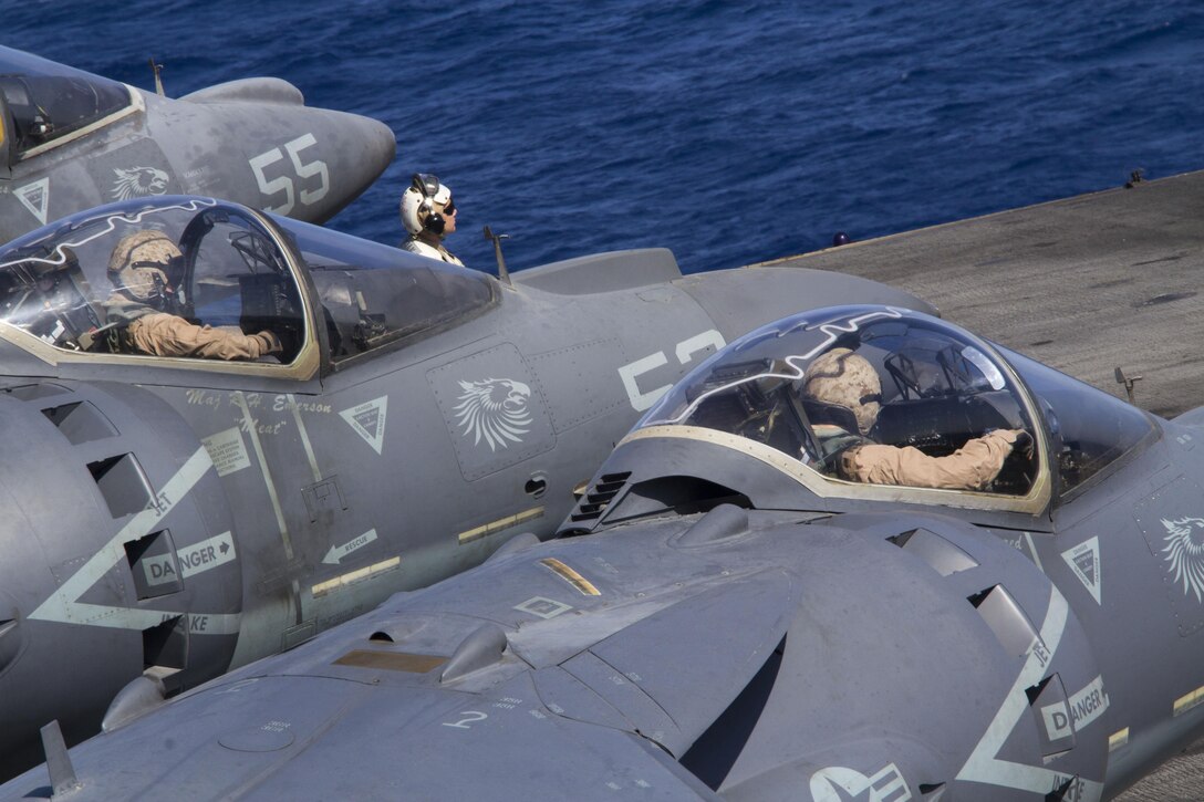 U.S. Marine Corps AV-8B Harrier pilots assigned to Marine Medium Tiltrotor Squadron (VMM) 266 (Reinforced), 26th Marine Expeditionary Unit (MEU), wait on the flight deck of the USS Kearsarge (LHD 3) before takeoff, at sea, July 14, 2013.  The 26th MEU is a Marine Air-Ground Task Force forward-deployed to the U.S. 5th Fleet area of responsibility aboard the Kearsarge Amphibious Ready Group serving as a sea-based, expeditionary crisis response force capable of conducting amphibious operations across the full  range of military operations. (U.S. Marine Corps photo by Cpl. Kyle N. Runnels/Released)