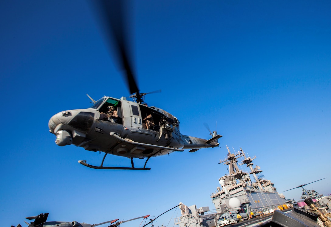 A U.S. Marine Corps UH-1N Huey assigned to Marine Medium Tiltrotor Squadron (VMM) 266 (Reinforced), 26th Marine Expeditionary Unit (MEU), takes off from the flight deck of the USS Kearsarge (LHD 3), at sea, July 13, 2013.  The 26th MEU is a Marine Air-Ground Task Force forward-deployed to the U.S. 5th Fleet area of responsibility aboard the Kearsarge Amphibious Ready Group serving as a sea-based, expeditionary crisis response force capable of conducting amphibious operations across the full  range of military operations. (U.S. Marine Corps photo by Sgt. Christopher Q. Stone/Released)