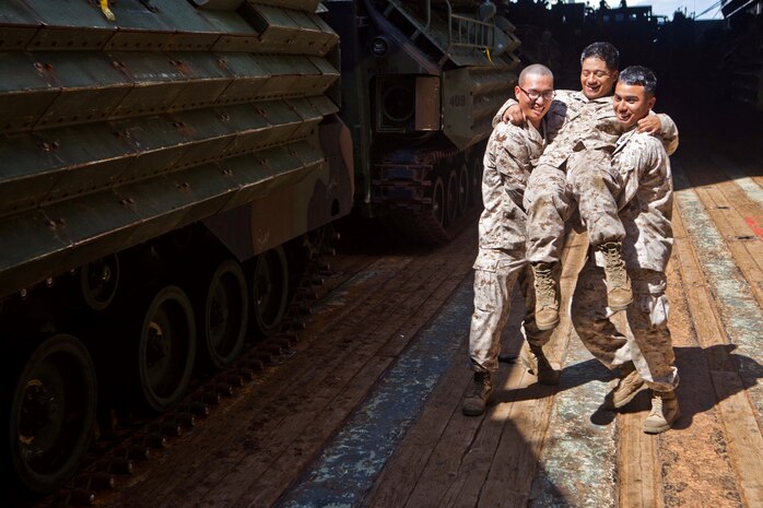 Marines with Combat Logistics Battalion 31, 31st Marine Expeditionary Unit, conduct a chair carry during the practical application exercise of a combat lifesaver course in the well deck here, July 4. Marines and Sailors with the 31st MEU and crew of the USS Germantown completed a three-day intermediate medical course that taught them a range of field medicine skills from splinting an arm fracture to applying a tourniquet to an arterial bleed. The 31st MEU is currently deployed on the three ships of Amphibious Squadron 11 in support of a regularly scheduled patrol of the Asia Pacific region.