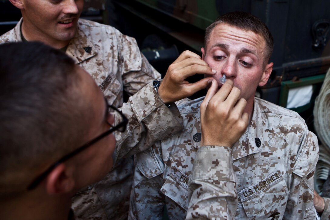 Staff Sgt. James A. Finegan, a radio chief for Combat Logistics Battalion 31, 31st Marine Expeditionary Unit, and native of Philadelphia, Penn., has a nasophryngeal airway (a plastic tube that allows breathing if oral breathing is unattainable) inserted into his nostril during the practical application portion of a combat lifesaver course in the well deck here, July 4. Marines and Sailors with the 31st MEU and crew of the USS Germantown completed a three-day intermediate medical course that taught them a range of field medicine skills from splinting an arm fracture to applying a tourniquet to an arterial bleed. The 31st MEU is currently deployed on the three ships of Amphibious Squadron 11 in support of a regularly scheduled patrol of the Asia Pacific region.