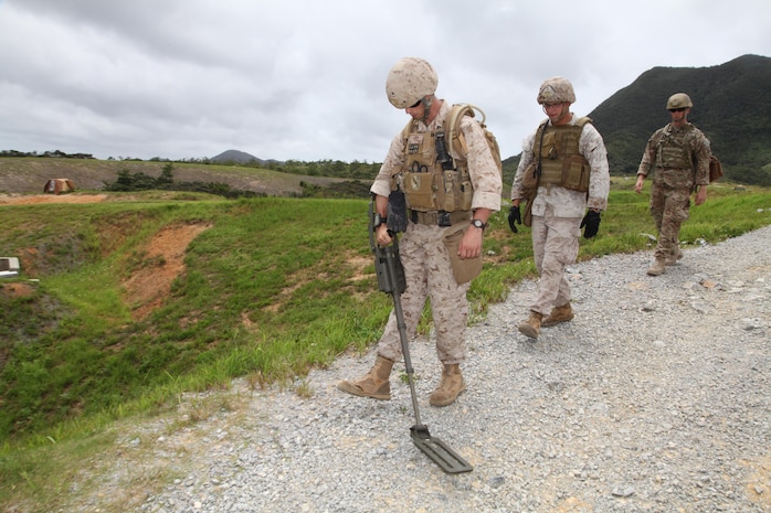 Marines search the surrounding area of a mock blast site June 26 at Camp Schwab. The training gave the Marines of 3rd Explosive Ordnance Disposal Company an opportunity to apply post-blast analysis and site survey techniques in a mock tactical environment. 3rd EOD Co. is part of 9th Engineer Support Battalion, 3rd Marine Logistics Group, III Marine Expeditionary Force. 