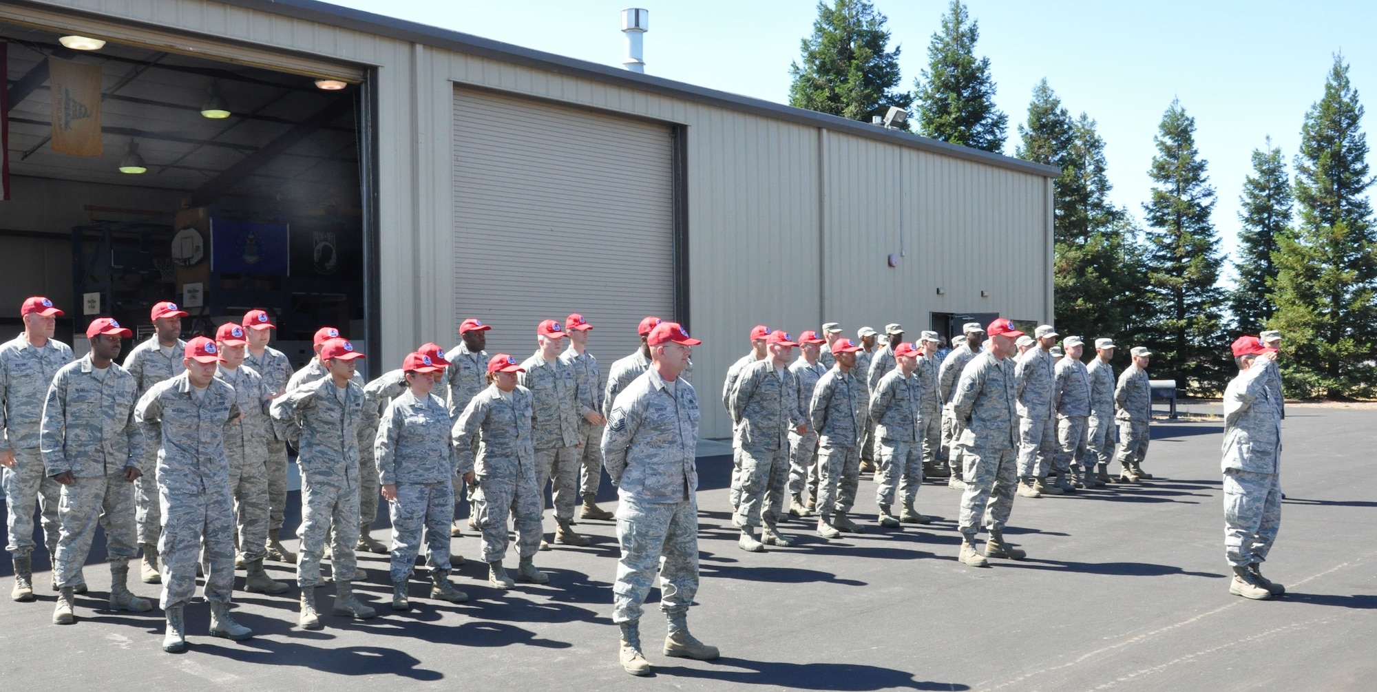 Members of the 940th Civil Engineering Squadron change hats from standard military issue to the RED HORSE cap during the stand up ceremony. The 583rd RED HORSE Squadron held a stand up ceremony July 13 during the unit training assembly at Beale Air Force Base, Calif., gaining members from the 940th Civil Engineering Squadron and the 9th CES. (U.S. Air Force photo Senior Airman Adam Hamar)