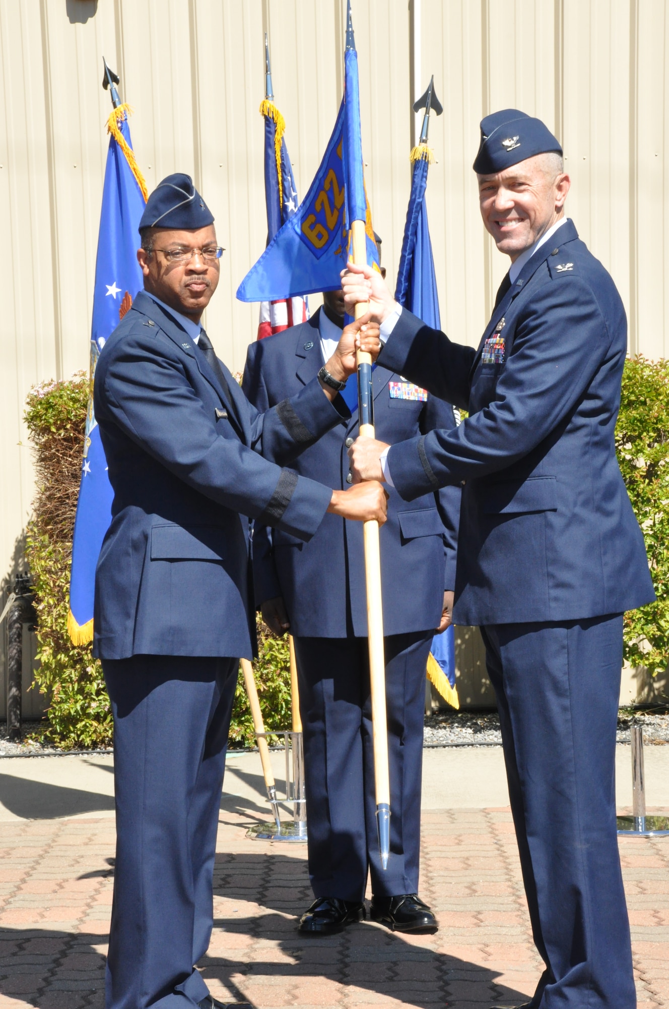 Brig Gen Curtis Williams passes Col Timothy Lamb the gideon for the new 583rd RED HORSE Squadron.  The 583rd RED HORSE Squadron held a stand up ceremony July 13 during the unit training assembly at Beale Air Force Base, Calif. The 583rd gained members from the 940th Civil Engineering Squadron and the 9th CES. (U.S. Air Force photo Senior Airman Adam Hamar)