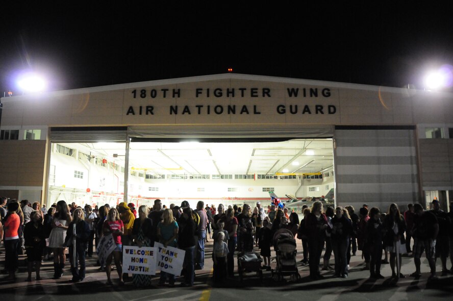 Family of deployed Airmen wait on the flight line for their loved ones to land at the 180th Fighter Wing, Toledo, Ohio, July 13, 2013. Approximately 200 Airmen from the 180th FW are returning from an Air Expeditionary Force deployment lasting just over two months. (Air National Guard photo by Staff Sgt. Amber Williams/Released)