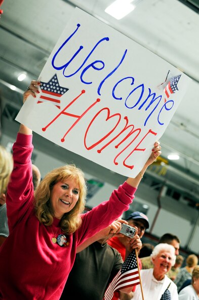 Sandy Bauman, waits to see her son, Tech. Sgt. Dustin Bauman, for the first time in over two months. Bauman, a fuel shop technician along with about 200 other 180th Fighter Wing members returned from an Air Expeditionary Force deployment lasting for just over two months. The 180th FW initially deployed to Djibouti, Africa in support of the Combined Joint Task Force-Horn of Africa (CJTF-HOA) to conduct stability operations in the area. At the end of June, members of the AEF were forward deployed to Muwaffaq Sulti AF, Azraq, Jordan, as part of Exercise Eager Lion. Eager Lion is a recurring, multinational exercise designed to strengthen military to military relationships and enhances regional security and stability by responding to modern day scenarios Air National Guard Photo by Master Sgt. Beth Holliker (Released).