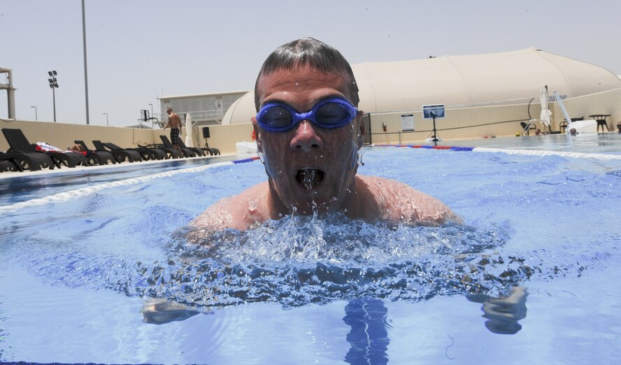 Royal Air Force Sgt. Scott Harrison from the No. 1 Air Control Center attached to the 727th Expeditionary Air Control Squadron, swims in the pool at an undisclosed location in Southwest Asia June 27, 2013. Harrison is deployed with three other RAF members, who used exercise as a means of raising money for charity and inspiring others on base. (U.S. Air Force photo/Senior Airman Jacob Morgan) 

