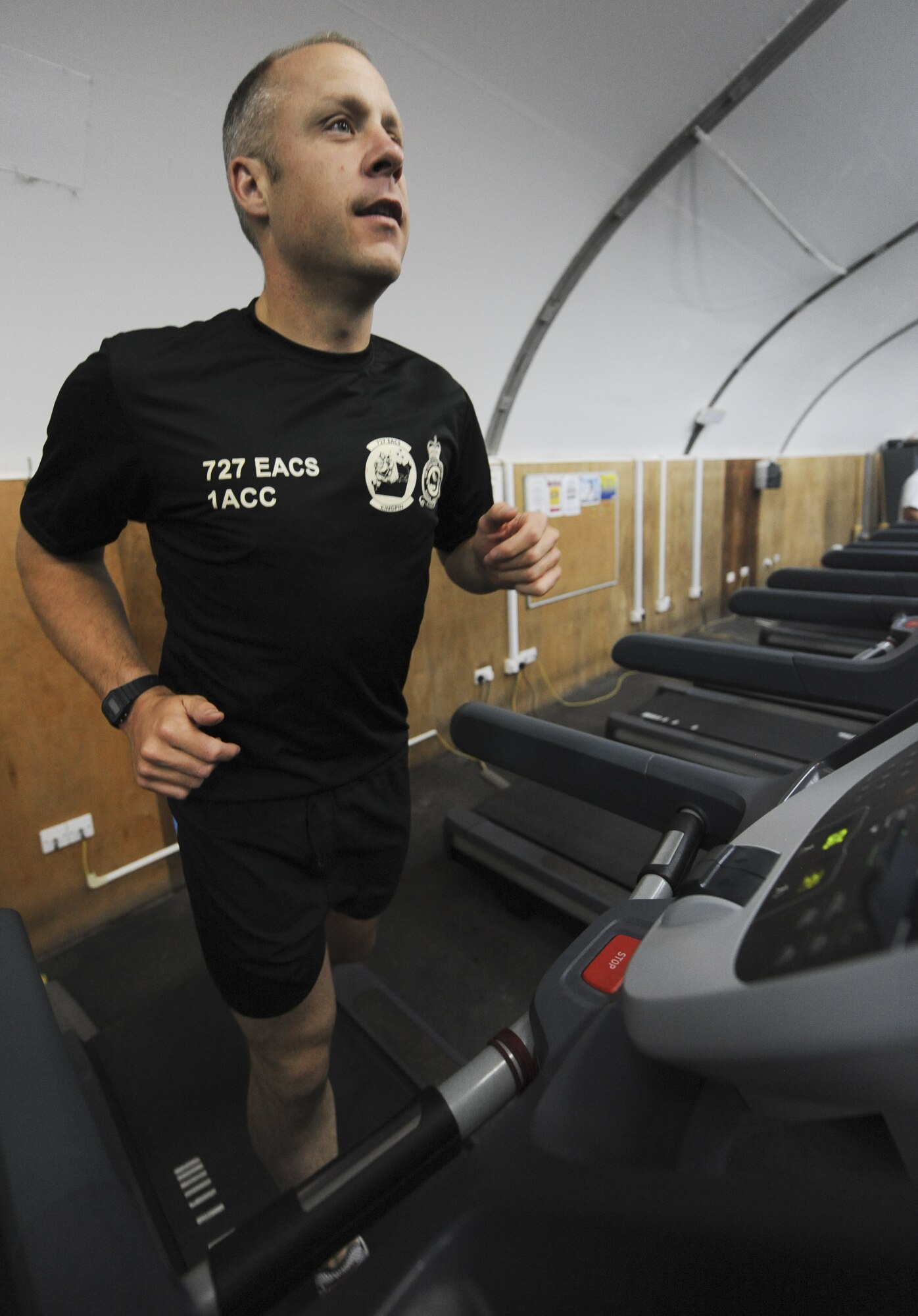 Royal Air Force Flight Sergeant Craig Burden from the No. 1 Air Control Center attached to the 727th Expeditionary Air Control Squadron, runs on a treadmill at the gym at an undisclosed location in Southwest Asia June 27, 2013. Burden is deployed with three other RAF members, who used exercise as a means of raising money for charity and inspiring others on base. (U.S. Air Force photo by Senior Airman Jacob Morgan)