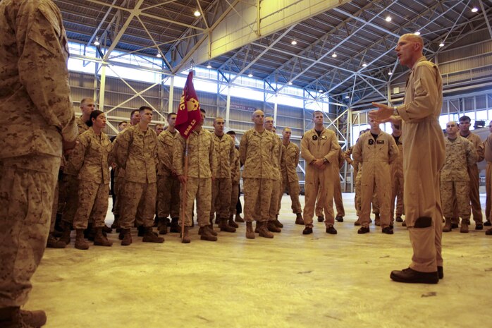 Maj. Gen. Christopher Owens, 1st Marine Air Wing commanding general, talks with servicemembers from Marine All-Weather Fighter Attack Squadron 242 in the VMFA(AW)-242 hangar at Marine Corps Air Station Iwakuni, Japan, June 28, 2013. Owens visited all of the wing units aboard station as part of his final tour as 1st MAW CG.