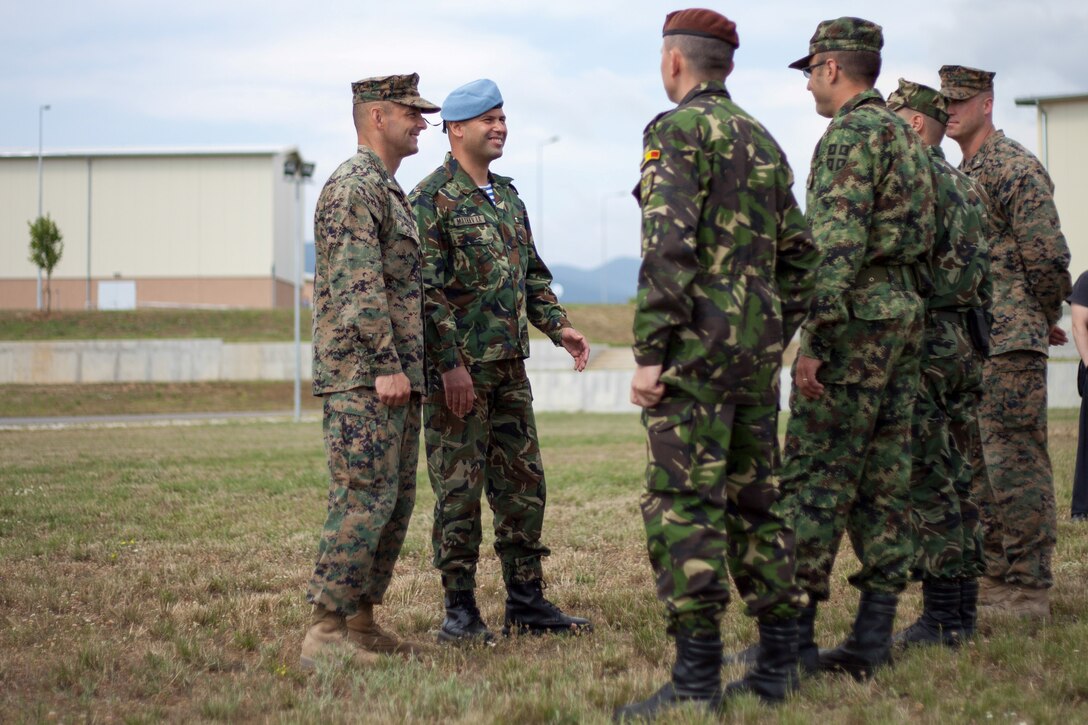 Lt. Col. Steven M. Wolf, left, commander of Black Sea Rotational Force 13, and Bulgarian Army Colonel Iavor Mateev, right, officer-in-charge of Bulgarian forces participating in BSRF-13, speak with Bulgarian, Serbian, Romanian and American company commanders at Novo Selo, Bulgaria, following an opening ceremony July, 1, 2013. The opening ceremony marked the beginning of Platinum Lion 13, BSRF-13’s five week exercise in Bulgaria. The exercise allows the U.S. and Balkan military forces to practice stability, counterinsurgency, and peacekeeping operations in order to build partner nation capacity, enhance interoperability between countries and increase the overall effectiveness of the participating partnered nations. (U.S. Marine Corps photo by 1st Lt. Hector Alejandro)