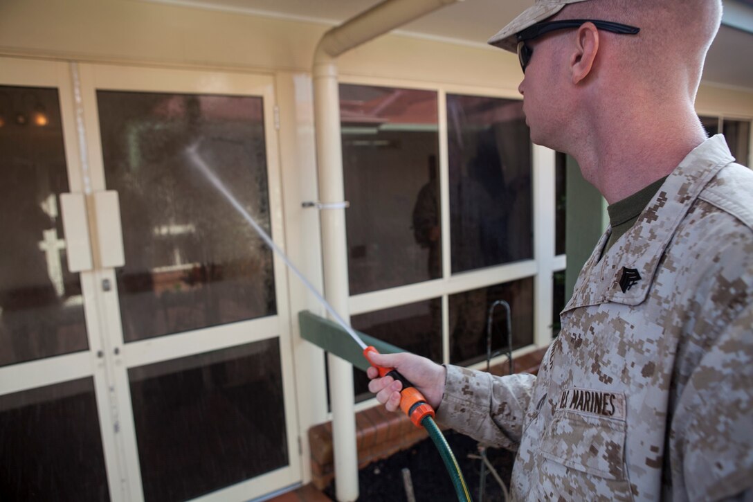Sergeant Jason R. Wehrer, the wrecker non-commissioned officer in charge with Combat Logistics Battalion 31, 31st Marine Expeditionary Unit, sprays down a window with a garden hose at Blue Care Nursing Home here, July 11. The Marines and Sailors of the 31st MEU and USS Bonhomme Richard cleaned the windows throughout the nursing home and then enjoyed morning tea with the residents. The 31st MEU is in Australia to participate in exercise Talisman Saber 13 as part of a scheduled deployment in support of regional security operations in the Asia Pacific. The 31st MEU is the Marine Corps’ force in readiness for the Asia Pacific region and the only continuously forward-deployed MEU.