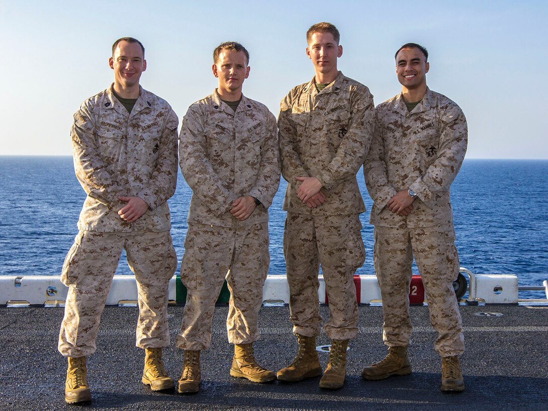 Combat Camerman and Public Affairs Marines assigned to the 26th Marine Expeditionary Unit (MEU) pose for a photo on the flight deck of the USS Kearsarge (LHD 3), at sea, July 15, 2013.  The 26th MEU is a Marine Air-Ground Task Force forward-deployed to the U.S. 5th Fleet area of responsibility aboard the Kearsarge Amphibious Ready Group serving as a sea-based, expeditionary crisis response force capable of conducting amphibious operations across the full  range of military operations. (Courtesy Photo/Released)