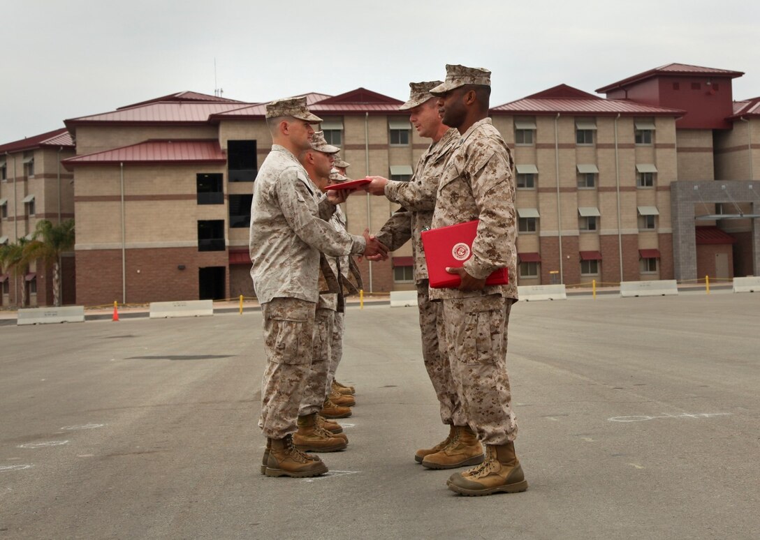 MARINE CORPS BASE CAMP PENDLETON, Calif. (July 11, 2013) Captain Scott B, Bayer, target information officer, Command Element, 15th Marine Expeditionary Unit, receives a Navy and Marine Corps Commendation Medal from Lt. Col. John R. O’Neal, commanding officer, 15th Marine Expeditionary Unit, during an awards ceremony held on the Camp Del Mar Parade Deck aboard Camp Pendleton, Calif., July 11. Bayer received the award for the superior performance of his duties as the unit’s target information officer. Bayer, 28, is from Bolivar, Mo. (U.S. Marine Corps photo by Cpl. Emmanuel Ramos/Released)