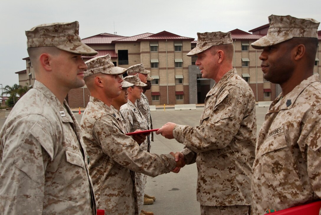 MARINE CORPS BASE CAMP PENDLETON, Calif. (July 11, 2013) Gunnery Sgt. Robert L. Lower, fires chief, Command Element, 15th Marine Expeditionary Unit, receives a Navy and Marine Corps Commendation Medal from Lt. Col. John R. O’Neal, commanding officer, 15th Marine Expeditionary Unit, during an awards ceremony held on the Camp Del Mar Parade Deck aboard Camp Pendleton, Calif., July 11. Lower received the award for the superior performance of his duties as the unit’s fire chief and substance abuse counselor. Lower, 32, Laporte, Ind. (U.S. Marine Corps photo by Cpl. Emmanuel Ramos/Released)