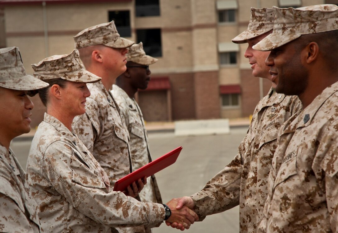 MARINE CORPS BASE CAMP PENDLETON, Calif. (July 11, 2013) Gunnery Sgt. Jennifer M. Antoine, public affairs chief, Command Element, 15th Marine Expeditionary Unit, receives a Navy and Marine Corps Achievement Medal from Lt. Col. John R. O’Neal, commanding officer, 15th Marine Expeditionary Unit, during an awards ceremony held on the Camp Del Mar Parade Deck aboard Camp Pendleton, Calif., July 11. Antoine received the award for the superior performance of her duties as the unit’s public affairs chief. Antoine, 40, is from Altoona Wis. (U.S. Marine Corps photo by Cpl. Emmanuel Ramos/Released)