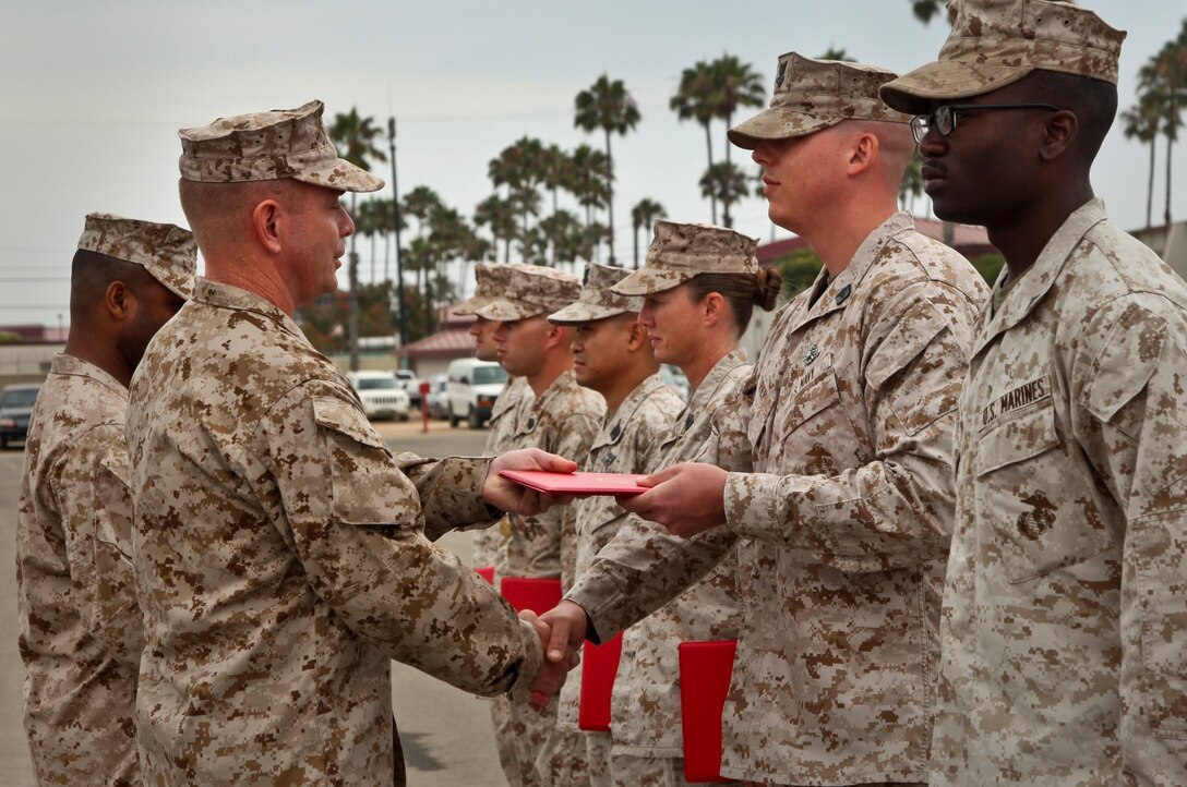 MARINE CORPS BASE CAMP PENDLETON, Calif. (July 11, 2013) Petty Officer Second 2nd Class Devin L. Turner, Fleet Marine Force hospital corpsman, 15th Marine Expeditionary Unit, receives a Navy and Marine Corps Achievement Medal from Lt. Col. John R. O’Neal, commanding officer, Command Element, 15th Marine Expeditionary Unit, during an awards ceremony held on the Camp Del Mar Parade Deck aboard Camp Pendleton, Calif., July 11. Turner received the award for the superior performance of his duties as the unit’s hospital corpsman. Turner, 30, is from Clovis, Calif. (U.S. Marine Corps photo by Cpl. Emmanuel Ramos/Released)