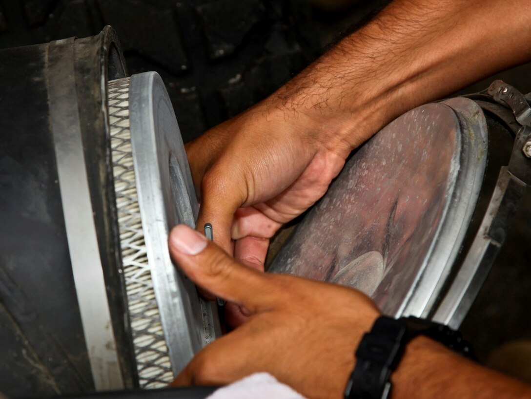 MARINE CORPS BASE CAMP PENDLETON, Calif. (July 11, 2013) Sergeant Thomas G. Ochoa, motor transportation maintenance chief, Command Element, 15th Marine Expeditionary Unit, inspects an air filter on a MII 56 High Mobility Multipurpose Wheeled Vehicle during weekly vehicle maintenance at the 15th MEU’s motor pool aboard Camp Pendleton, Calif., July 11. Marines with the MEU conduct preventative maintenance weekly on tactical vehicles to ensure unit readiness. Ochoa, 29, is from Los Angeles. (U.S. Marine Corps photo by Cpl. Emmanuel Ramos/Released)