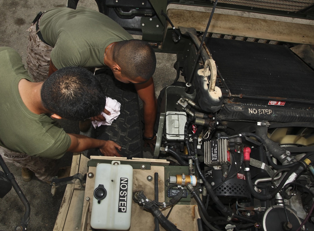 MARINE CORPS BASE CAMP PENDLETON, Calif. (July 11, 2013) Sergeant Thomas G. Ochoa (right), motor transportation maintenance chief, Command Element, 15th Marine Expeditionary Unit, instructs Pfc. Diego Retamozo(left), administrative clerk, CE, 15th MEU, how to properly inspect the suspension system on a MII 56 High Mobility Multipurpose Wheeled Vehicle during weekly vehicle maintenance at the 15th MEU’s motor pool aboard Camp Pendleton, Calif., July 11. Marines with the MEU conduct preventative maintenance weekly on tactical vehicles to ensure unit readiness. Ochoa, 29, is from Los Angeles. Retamozo, 20, is from Perth Amboy, N.J. (U.S. Marine Corps photo by Cpl. Emmanuel Ramos/Released)