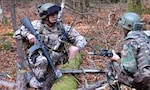 A Latvian soldier and an Afghan soldier communicate during Operational Mentor and Liaison Team training at the Joint Multinational Readiness Center at the Hohenfels Training Area.
