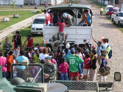 Members of the Paraguayan Multi-Role Engineer Company build positive relations with the local community by giving rides to local children in July 2008.