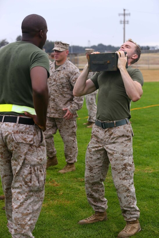 Cpl. Jonathan Waldman, 11th Marine Expeditionary Unit combat photographer, conducts ammo can lifts duing the combat fitness test here July 12. (Photo by: U.S. Marine Corps Staff Sgt. Jimmy H. Bention, Jr. Public Affairs, 11TH Marine Expeditionary Unit)