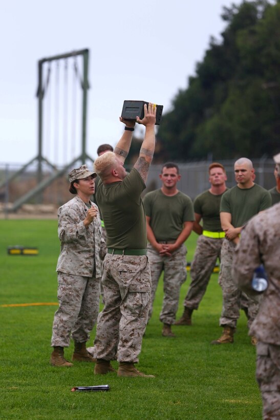 Staff Sgt. Sean Fordham, 11th Marine Expeditionary Unit NBC chief, demonstrate the ammo can lift during a combat fitness test here July 12. (Photo by: U.S. Marine Corps Cpl. Jonathan R. Waldman, Combat Camera, 11TH Marine Expeditionary Unit)