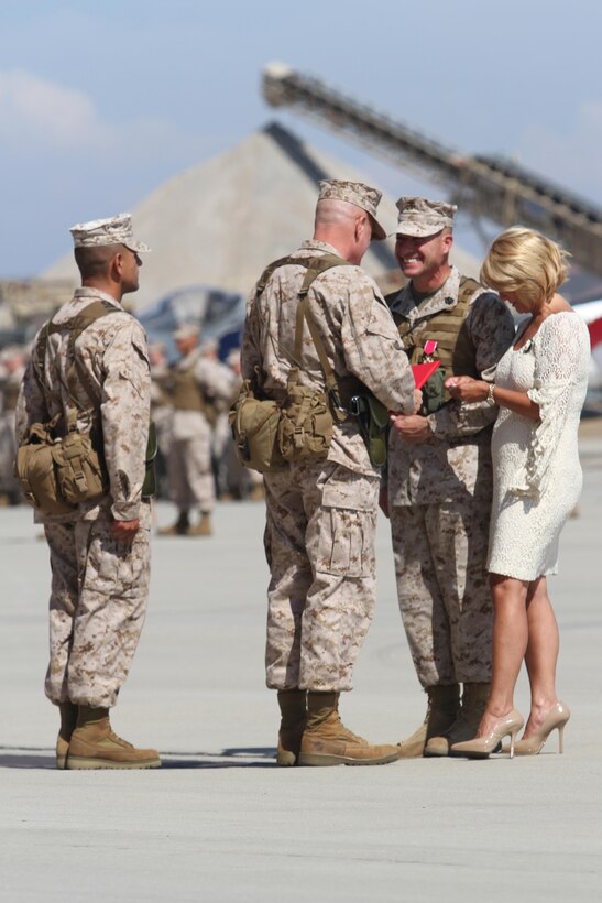 Maj. Gen. Steven W. Busby, 3rd Marine Aircraft Wing commanding general, presents the Legion of Merit awards to Sgt. Major Anthony A. Spadaro, the off-going 3rd MAW sergeant major, during the sergeant major’s relief ceremony aboard Marine Corps Air Station Miramar, Calif. July 12. Spadaro was commended for mitigating potential threats to the mission and for being a proprietor of the commanding general’s committed and engaged leadership initiative.