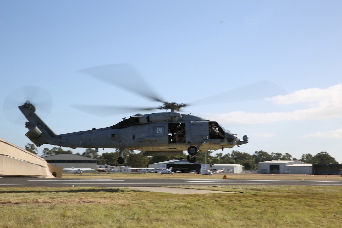 An SH-60H Seahawk assigned to the Firehawks of Helicopter Sea Combat Squadron 85 (HSC-85) takes off from Rockhampton Airport. The Firehawks will provide aerial support to Exercise Talisman Saber 2013. The biennial exercise enhances multilateral collaboration between U.S. and Australian forces in support of future combined operations, humanitarian emergencies and natural disasters. (U.S. Marine Corps photo by Cpl. James Gulliver/RELEASED)