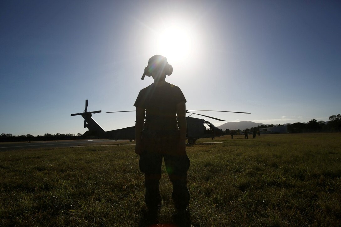 U.S. Navy Aviation Machinist's Mate Airman Kristen Mehulk, assigned to the Firehawks of Helicopter Sea Combat Squadron 85 (HSC-85), watches an SH-60H Seahawk prepare for takeoff from Rockhampton Airport. The Firehawks will provide aerial support to Exercise Talisman Saber 2013. The biennial exercise enhances multilateral collaboration between U.S. and Australian forces in support of future combined operations, humanitarian emergencies and natural disasters. (U.S. Marine Corps photo by Cpl. James Gulliver/RELEASED)