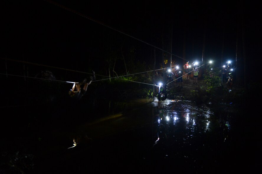 Participants cross a rope bridge on Barksdale Air Force Base, La., July 12, 2013. As a safety concern, participants were given an alternate option to wade through the water. (U.S. Air Force photo/Senior Airman Micaiah Anthony)