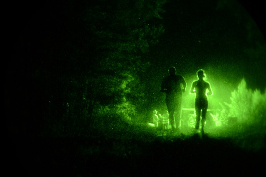 Participants jog toward a water station on Barksdale Air Force Base, La., July 12, 2013. Several water stations staffed with medical personnel were strategically placed along the race route to ensure the safety of the runners. (U.S. Air Force photo/Senior Airman Micaiah Anthony)