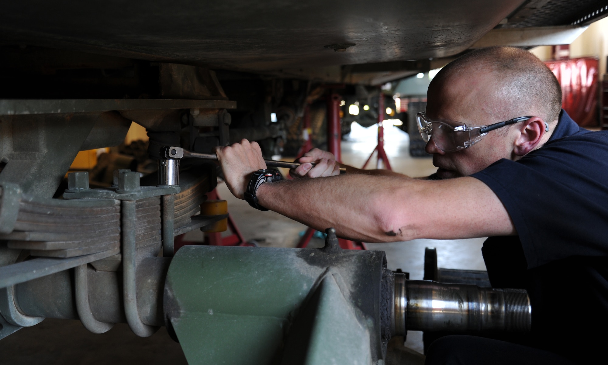 Maj. Kelly Hannum, 336th Training Support Squadron commander, removes the U-Bolt nuts of a Tucker Terra Sno-Cat at Fairchild Air Force Base, Wash., July 9, 2013. Hannum periodically participates in the work his Airmen perform to get a better understanding in what they do. (U.S. Air Force photo by Airman 1st Class Janelle Patiño/Released)