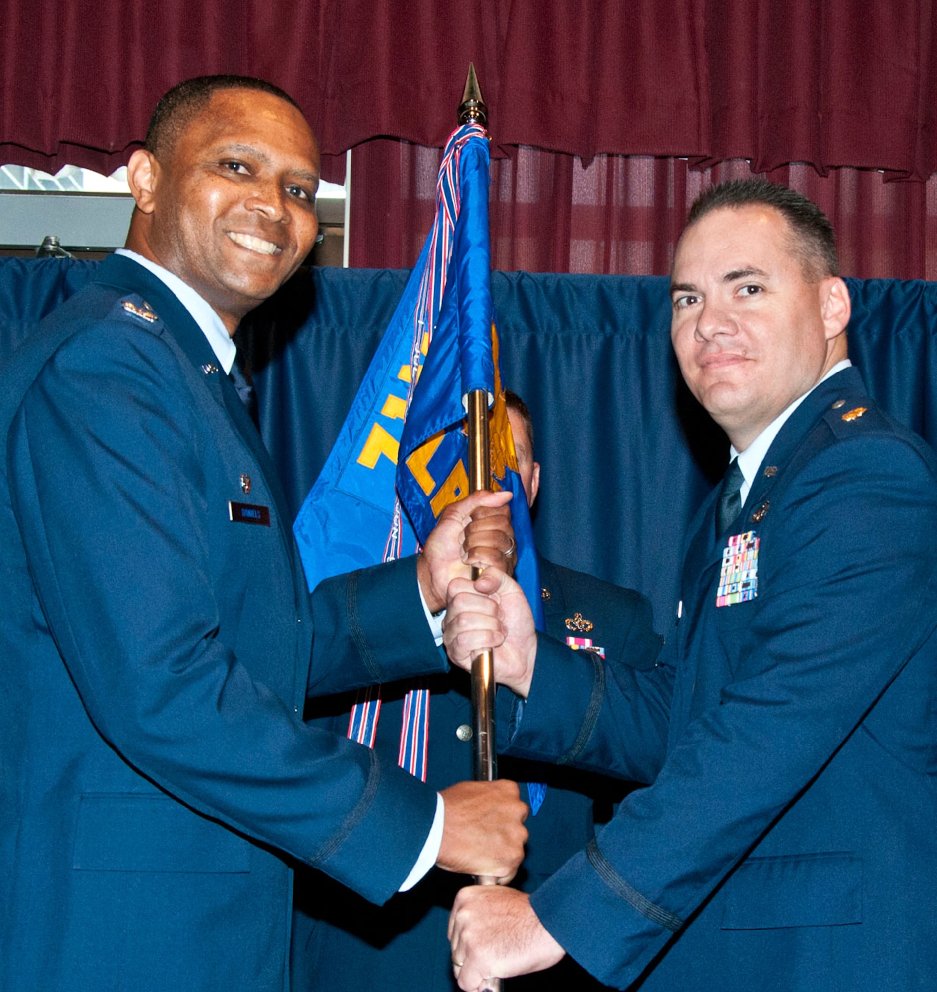 Maj. John “Mark” Klohr, right, accepts the 71st Logistics Readiness Squadron guidon from Col. Christopher Daniels, 71st Mission Support Group commander, during a 71st LRS change of command ceremony held July 12 at the Vance Collocated Club at Vance Air Force Base, Okla. (U.S. Air Force photo/ Terry Wasson)