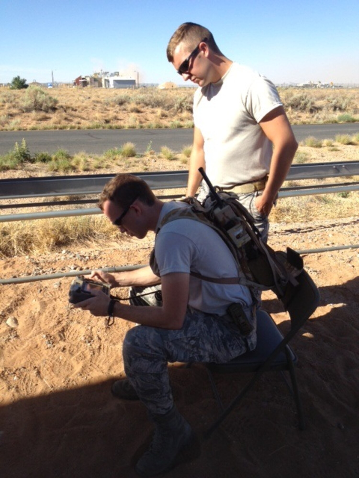 Airman 1st Class Reed Fitzhugh and Staff Sgt. Nick Adkisson (standing), 377th Explosive Ordnance Disposal Flight, operate a robot via remote control at the Western National Robot Rodeo. The Kirtland team beat eight other teams to win first place in the competition. (Courtesy photo)