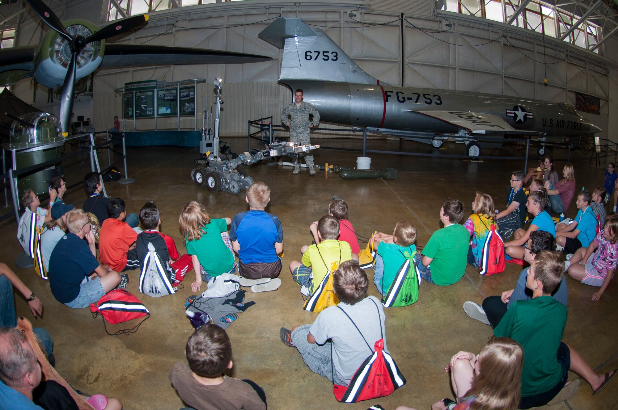 Senior Master Sgt. Eric Eberhard, a 419th explosive ordnance disposal technician, talks with a group of 6th and 7th graders from a local aerospace summer camp at the Hill Aerospace Museum Friday. (U.S. Air Force Photo/Senior Airman Crystal Charriere)