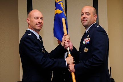 Lt. Col Patrick Miller (right) , accepts the guidon from Col. Justin Davey, 628th Mission Support Group commander, during the 628th Civil Engineer Squadron change of command ceremony July 11, 2013, at the Charleston Club on Joint Base Charleston – Air Base, S.C. Miller assumed command from Lt. Col. Aaron Altweis .  (U.S. Air Force photo/Staff Sgt. Rasheen Douglas)