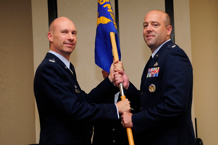 Lt. Col Patrick Miller (right) , accepts the guidon from Col. Justin Davey, 628th Mission Support Group commander, during the 628th Civil Engineer Squadron change of command ceremony July 11, 2013, at the Charleston Club on Joint Base Charleston – Air Base, S.C. Miller assumed command from Lt. Col. Aaron Altweis .  (U.S. Air Force photo/Staff Sgt. Rasheen Douglas)