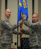 Lt. Col. James Hodges (right), accepts the guidon from Col. Justin Davey, 628th Mission Support Group commander, during the 628th Security Forces Squadron change of command ceremony July 10, 2013, at the Charleston Club on Joint Base Charleston – Air Base, S.C. Hodges assumed command from Lt. Col. Frances Dorish. (U.S. Air Force photo/Staff Sgt. Rasheen Douglas)