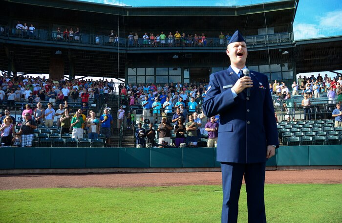 Airman 1st Class Michael Reeves, 628th Air Base Wing Public Affairs broadcaster, sings the National Anthem during Military Appreciation Night July 13, 2013, at the Joseph P. Riley Jr. ballpark in Charleston, S.C. Reeves performed for more than 5,000 attendees. (U.S. Air Force photo/ Staff Sgt. Anthony Hyatt)