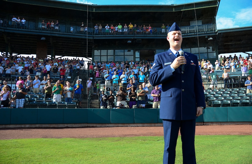 Airman 1st Class Michael Reeves, 628th Air Base Wing Public Affairs broadcaster, sings the National Anthem during Military Appreciation Night July 13, 2013, at the Joseph P. Riley Jr. ballpark in Charleston, S.C. Reeves performed for more than 5,000 attendees. (U.S. Air Force photo/ Staff Sgt. Anthony Hyatt)