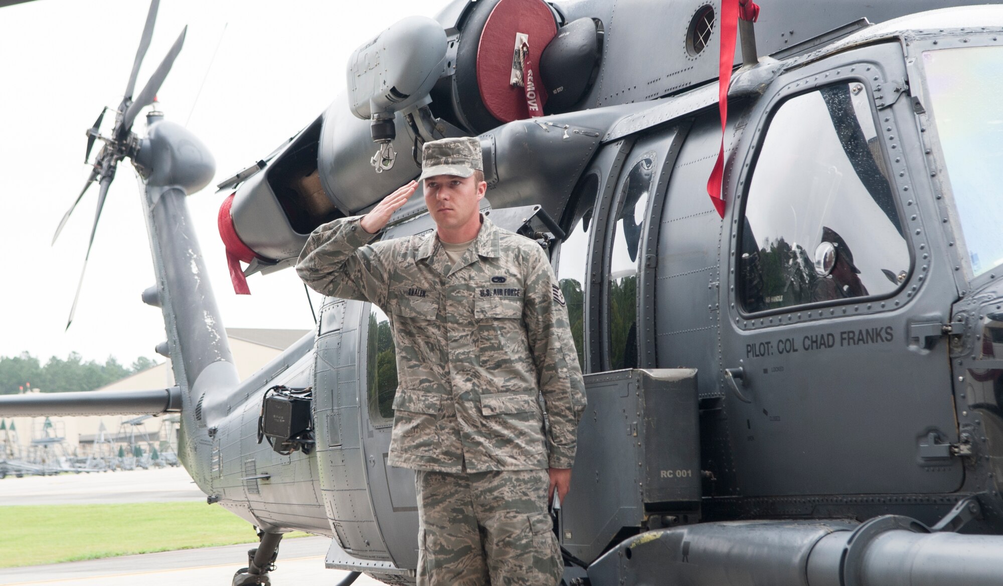 U.S. Air Force Staff Sgt. Scott Shalek, 723d AMXS aerospace propulsion journeyman, salutes incoming 23d Wing commander, Col. Chad Franks, during a wing change of command ceremony at Moody Air Force Base, Ga., July 12, 2013. Shalek rendered the salute after revealing Franks’ name on an HH-60G Pave Hawk, signifying the change of command. (U.S. Air Force Photo by Airman 1st Class Sandra Marrero/released) 
