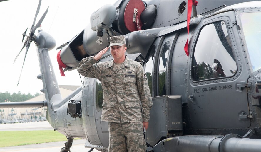 U.S. Air Force Staff Sgt. Scott Shalek, 723d AMXS aerospace propulsion journeyman, salutes incoming 23d Wing commander, Col. Chad Franks, during a wing change of command ceremony at Moody Air Force Base, Ga., July 12, 2013. Shalek rendered the salute after revealing Franks’ name on an HH-60G Pave Hawk, signifying the change of command. (U.S. Air Force Photo by Airman 1st Class Sandra Marrero/released) 
