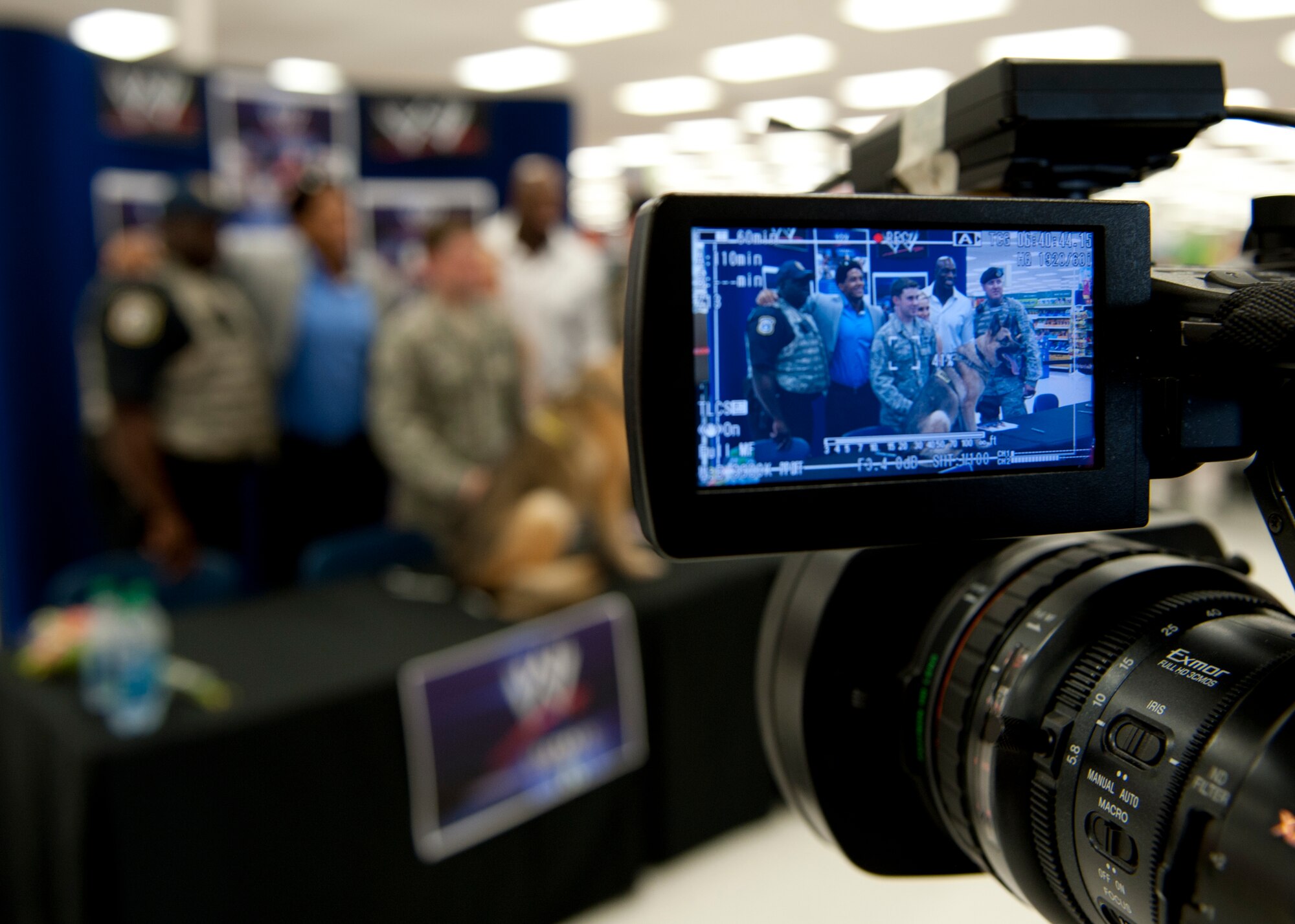 Members of the 633rd Security Forces Squadron take a group photo with WWE Superstars Darren Young and Titus O’Neil, and WWE Diva Natalya at the Exchange on Langley Air Force Base, July 9, 2013. The WWE entertainers signed autographs and took photos with Joint Base Langley-Eustis Soldiers, Airmen and their families. (U.S. Air Force photo by Staff Sgt. John D. Strong II/Released)